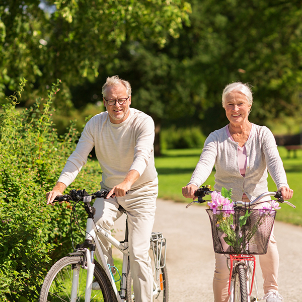 senior couple bicycling outside